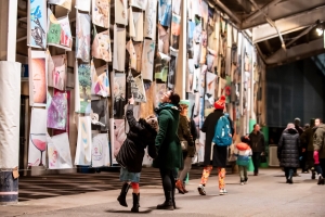 Mother_and_daughter_view_hanging_artworks._The_Awakening